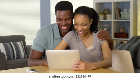 Smiling Young Black Couple Waving And Having Video Chat With Family Over Tablet