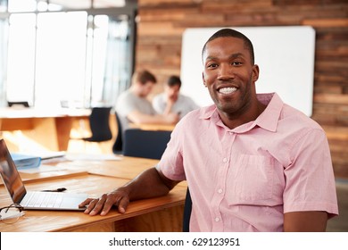 Smiling Young Black Man In Creative Office Looking To Camera