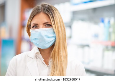 Smiling Young Blonde Pharmacist Wearing Covid Coronavirus Mask Inside Her Pharmacy