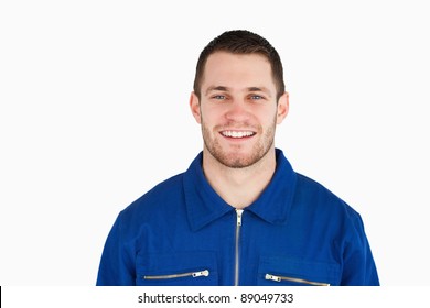 Smiling Young Blue Collar Worker Against A White Background