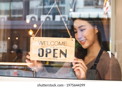 Smiling Young  Business Owner, Employee Retail,coffee Shop Woman,girl Turning,setting Sign Board To Open For Welcome Customer, Reopen Store After Close Lockdown Quarantine In Covid.Label Concept.