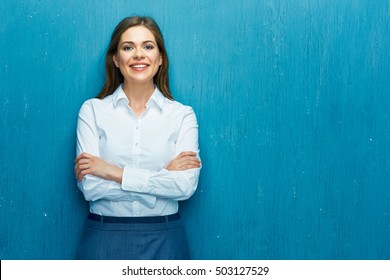 Smiling Young Business Woman Against Blue Wall. White Shirt Dressed.