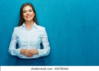 Smiling Young Business Woman Portrait On Blue Wall Background. White Shirt.