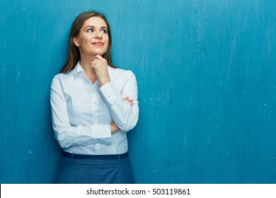 Smiling Young Business Woman Portrait On Blue Wall Background. White Shirt.