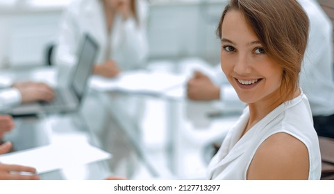 smiling young business woman at workplace in office - Shutterstock ID 2127713297