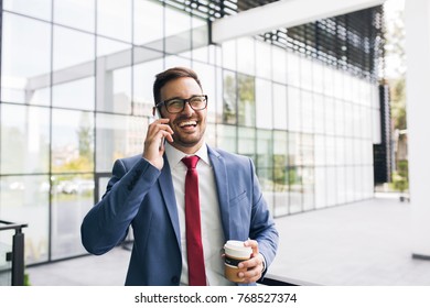 Smiling young businessman having break and speaking on the phone - Shutterstock ID 768527374
