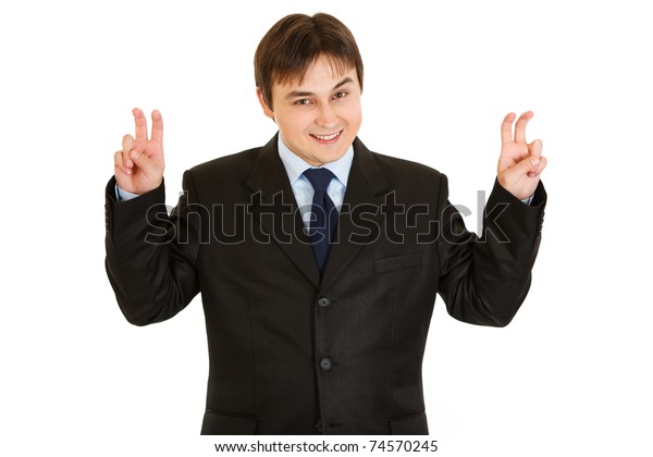 Smiling young  businessman showing air quotes gesture  isolated on white