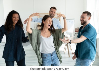 Smiling young businesswomen and businessmen dancing after successful deal. Diverse happy employee energy moving for break and relaxing. Motivated carefree multiracial business team. - Shutterstock ID 1733597897