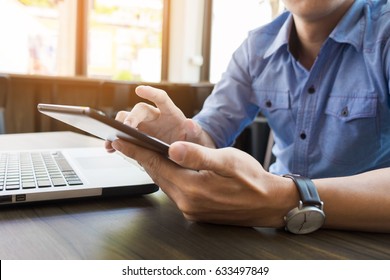 Smiling Young Casual Business Man With Mobile Phone In The Hand In Office.