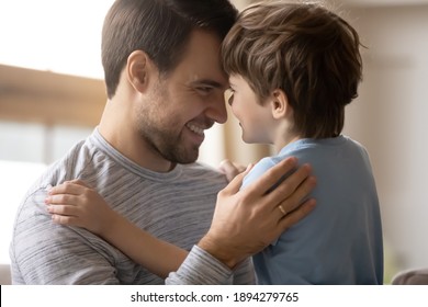 Smiling Young Caucasian Father And Small Preschooler Son Look In Eyes Have Tender Close Moment Together. Happy Dad And Little Boy Child Feel Grateful Thankful Show Love And Care. Family Concept.