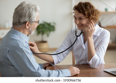 Smiling young Caucasian female doctor hold stethoscope listen to elderly male patient heart rate. Happy caring woman nurse use phonendoscope measure heartbeat of mature man in hospital.