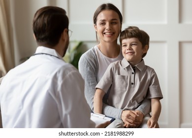 Smiling young Caucasian mother with small boy patient do checkup in private clinic with pediatrician. Happy mom and little child examine consult at doctor office in hospital. Healthcare concept. - Powered by Shutterstock