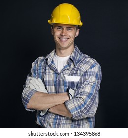 Smiling Young Construction Worker On A Black Background