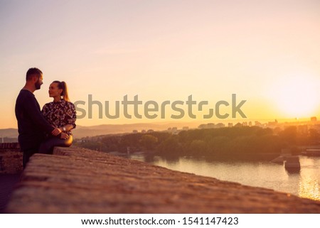 Smiling young  couple spend time together at sunset