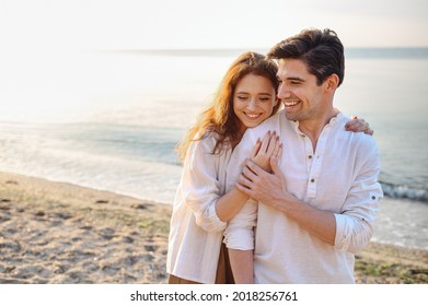 Smiling young couple two friends family man woman 20s in casual clothes hug girlfriend put head on boyfriend shoulder at sunrise over sea sand beach ocean outdoor seaside in summer day sunset evening - Shutterstock ID 2018256761
