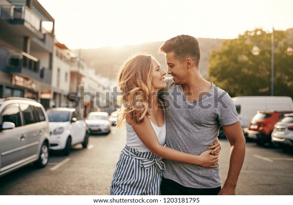 Smiling Young Couple Walking Arm Arm Stock Photo Edit Now