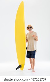 Smiling Young Curly Surfer Showing Shaka Or Hang Loose Sign Gesture And Holding Surfboard Isolated On The White Background