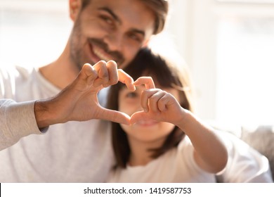 Smiling Young Dad And Little Daughter Hug Showing Love Sign Express Family Bonding And Care, Happy Parent Embrace Preschooler Girl Kid Make Hand Heart Gesture, Enjoy Tender Moment Together