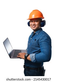 Smiling Young Engineer Holding A Notebook, Wearing A Helmet And Earmuff. On A White Background With Clipping Path And Cut Out