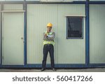 Smiling young engineer in protective work 