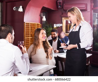 Smiling Young Family Having Date In Middle Class Restaurant. Focus On Blonde Girl