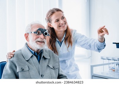 Smiling young female oculist helping her aged male patient checking sight using spectacles. Caucasian female optometrist selecting glasses eye lenses for senior man - Powered by Shutterstock