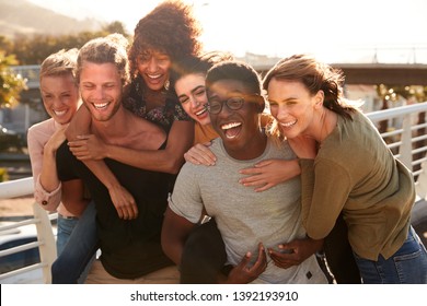 Smiling Young Friends Walking Outdoors Together