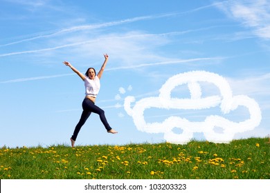 Smiling Young Girl Jumping Against Blue Sky Is Pleased About Her First Car