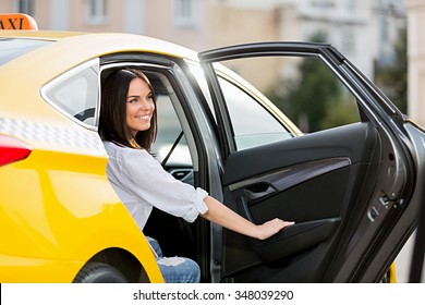 Smiling young girl in a taxi