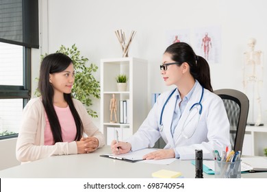 Smiling Young Girl Teenager Getting Flu Sick And Visiting Professional Doctor To Consultation Ill Problem In Clinic Office.