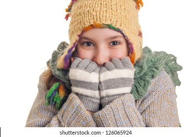 Smiling young girl in warm winter clothes isolated on white