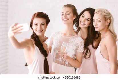 Smiling young girls taking a selfie together - Powered by Shutterstock