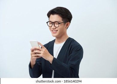 Smiling Young Good Looking Asian Man Using Smartphone 