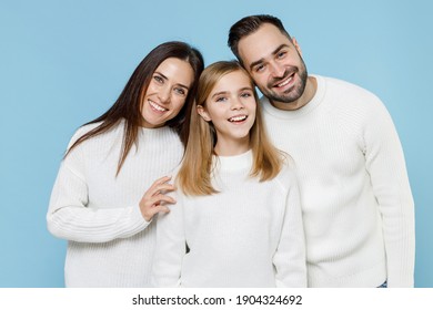 Smiling Young Happy Parents Mom Dad With Child Kid Daughter Teen Girl In Basic White Sweaters Looking Camera Isolated On Blue Color Background Studio Portrait. Family Day Parenthood Childhood Concept