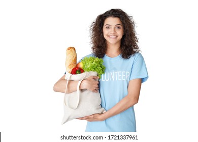 Smiling Young Hispanic Latin Woman Courier Wears Volunteer Tshirt Look At Camera Holding Eco Bag Deliver Grocery Food Delivery Social Donation Stand Isolated On White Studio Background. Portrait.