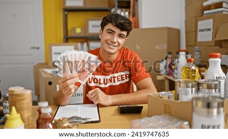 Smiling young hispanic teenager joyfully volunteers at charity center, confidently holding iceland krona banknotes