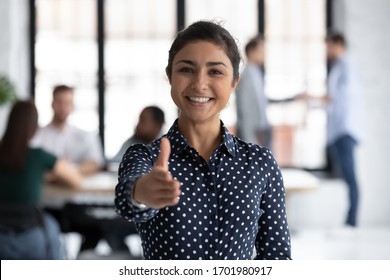 Smiling Young Indian Businesswoman Look At Camera Stretch Hand Welcome New Employee At Workplace, Happy Biracial Female Recruiter Meeting Greeting Newcomer Newbie In Office, Employment Concept