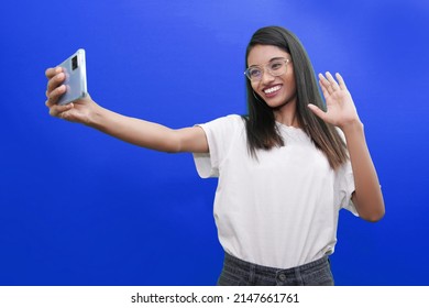 Smiling Young Indian Or South Asian Woman Talking By Video Call Or Dating Online Looking At Phone. Video Blogger Vlogger Recording Vlog At Home. Lifestyle Vlogging Concept, Head Shot Portrait