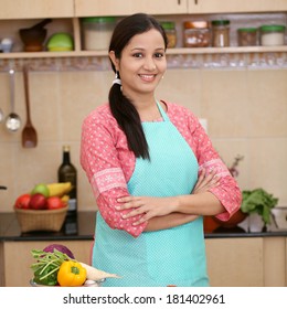 Smiling Young Indian Woman In Her Kitchen 