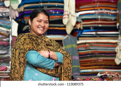 Smiling Young Indian Woman Weaver At Whool Shawl Shop Clothing