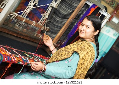 Smiling Young Indian Woman Weaver Working On Loom Manufacturing Whool Shawl Clothing