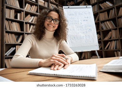 Smiling Young Latin School Math Teacher Looking At Webcam Giving Remote Class. Female Hispanic Tutor Coach Virtual Teaching Online Lesson By Video Conference Zoom Call Concept, Headshot Portrait.