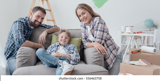 Smiling Young Loving Family Posing In Their New House, Relocation And Home Improvement Concept