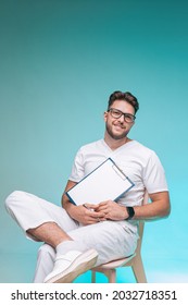 Smiling Young Male Physician Successful Handsome Practitioner In Glasses With Blank Space Sheet For Doctor Report