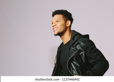 Smiling Young Man In Black Jacket With Big Smile Looking Up	