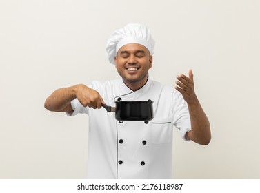 Smiling Young Man Chef In Uniform Gesture Smelling Empty Hot Pot Stew Soup Delicious Dish Menu Good Taste On Isolated. Cooking Man Occupation Chef People In Kitchen Restaurant And Hotel.