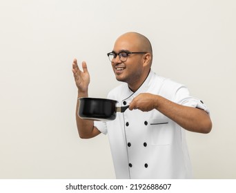 Smiling Young Man Chef In Uniform Gesture Smelling Empty Hot Pot Delicious Dish Menu Good Taste On Isolated. Cooking  Man Occupation Chef People In Kitchen Restaurant And Hotel.