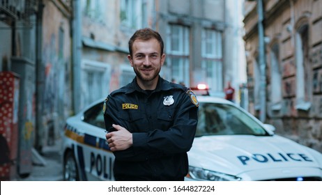 Smiling Young Man Cops Stand Near Patrol Car Look At Camera Wear Glasses Enforcement Happy Officer Police Uniform Auto Safety Security Communication Control Policeman Close Up Slow Motion