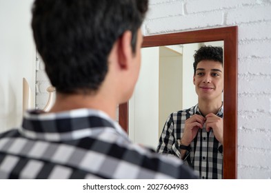 Smiling Young Man In Front Of The Mirror Getting Ready For A Date