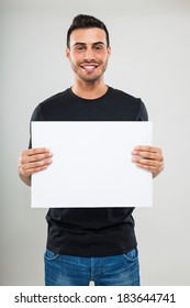 Smiling Young Man Holding A White Board